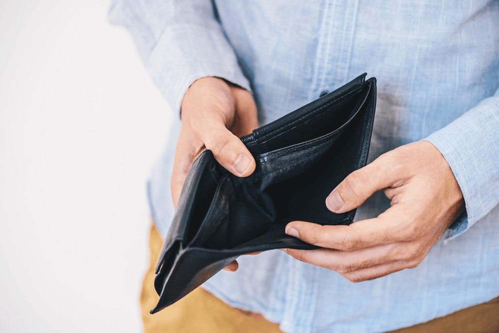 Man holding empty wallet.